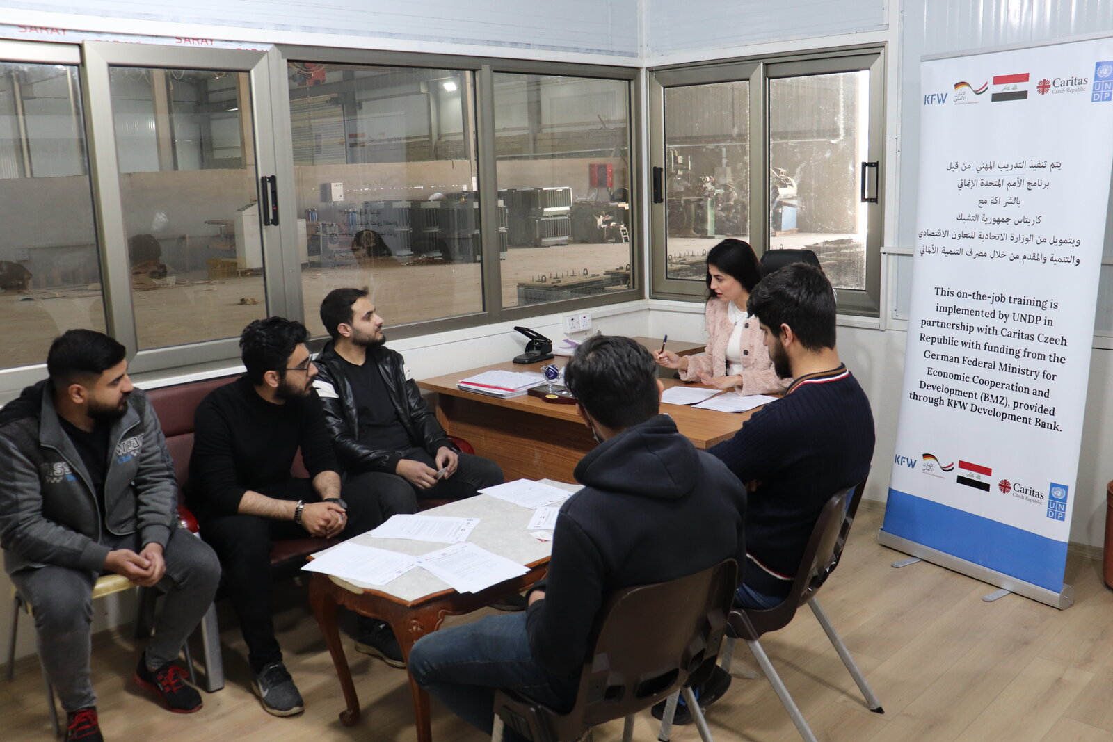 Five electrical engineers who were hired by the same company after participating in on-the-job training